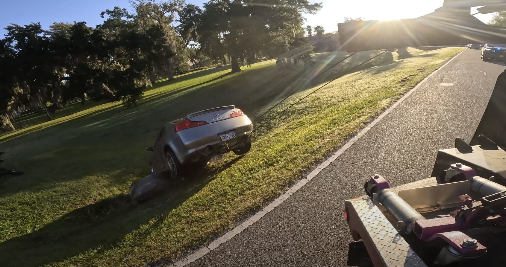 Sedan vehicle being safely recovered on quiet residential street