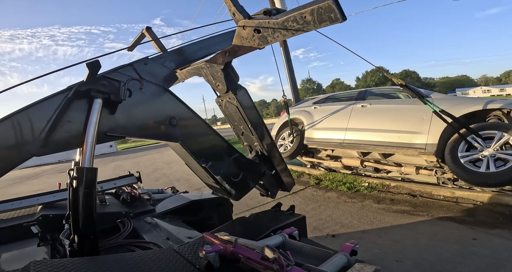 Flatbed tow truck safely loading luxury sedan for transport
